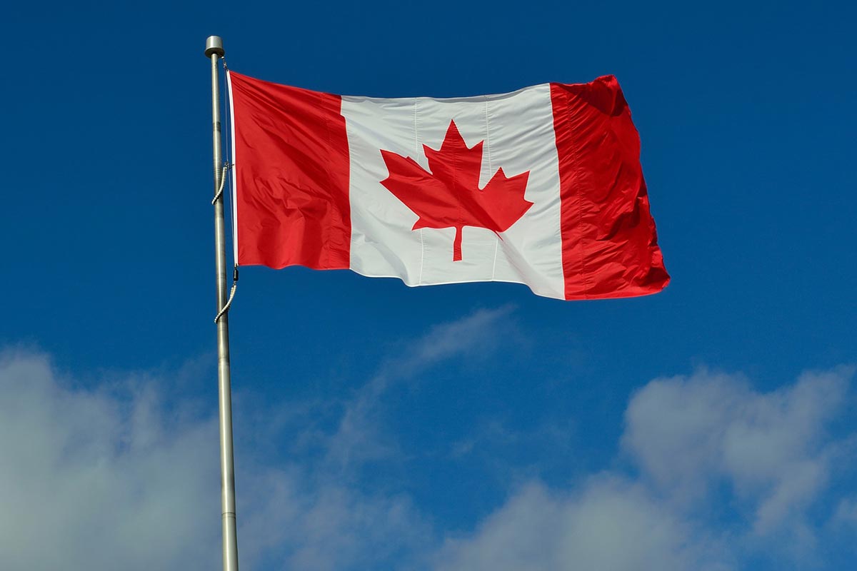 The Canadian flag against a blue sky