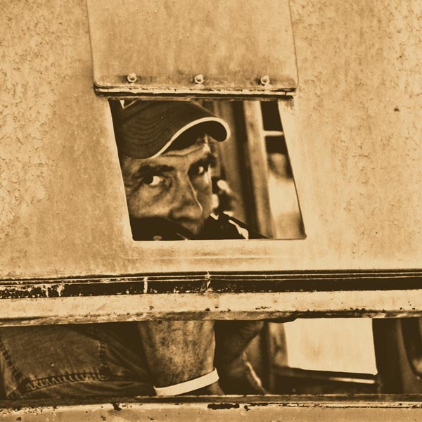 Murray McNab peaking out of the front window of his tractor