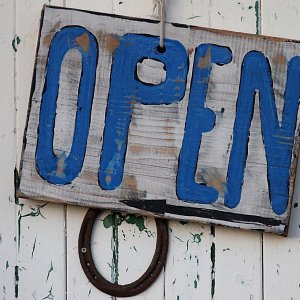 A wooden open sign